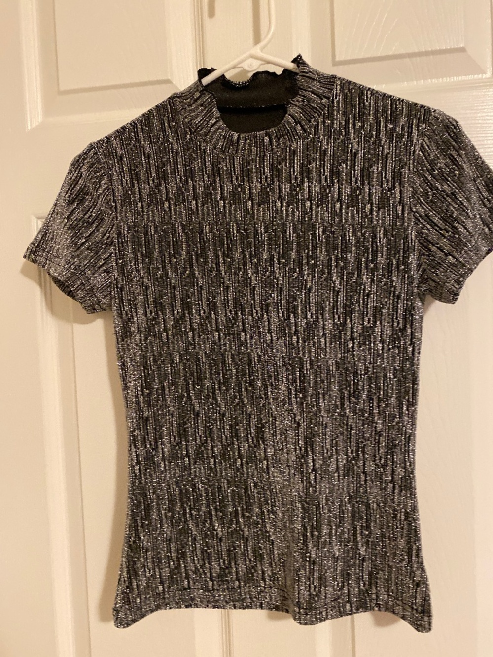 Black base with shiny silver blouse, very stretchy and form fitting